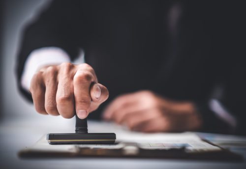 Close-up,Of,A,Person's,Hand,Stamping,With,Approved,Stamp,On